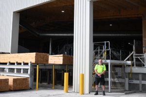 Russell standing in front of the Russell Ede Factory